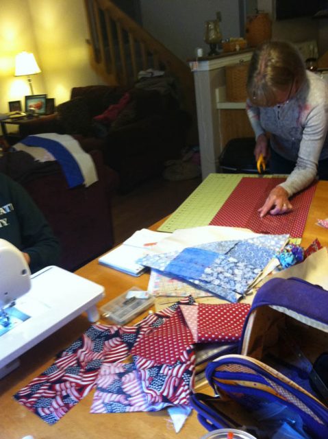 Mom got to cutting, the pattern was designed for charm squares but we used 15 quarter yards and 5 fat quarters