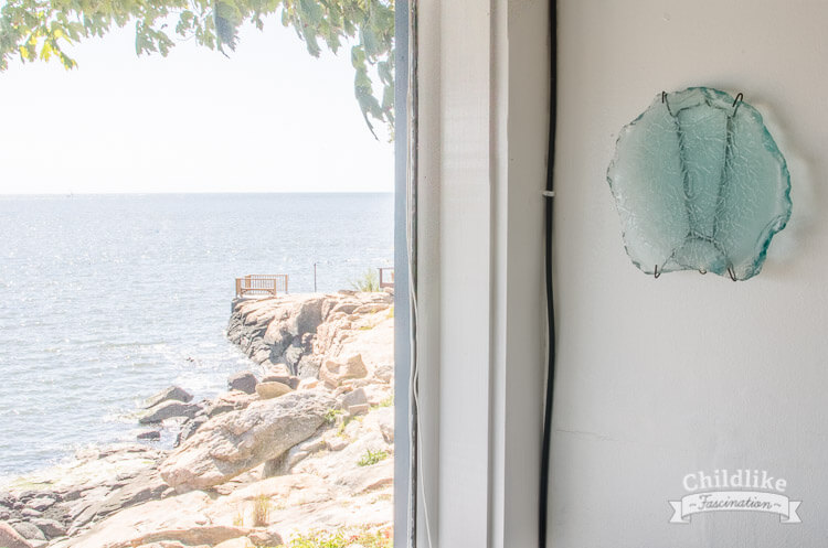 The piece of sea glass hanging on the wall and the view of the bay - ChildlikeFascination.com